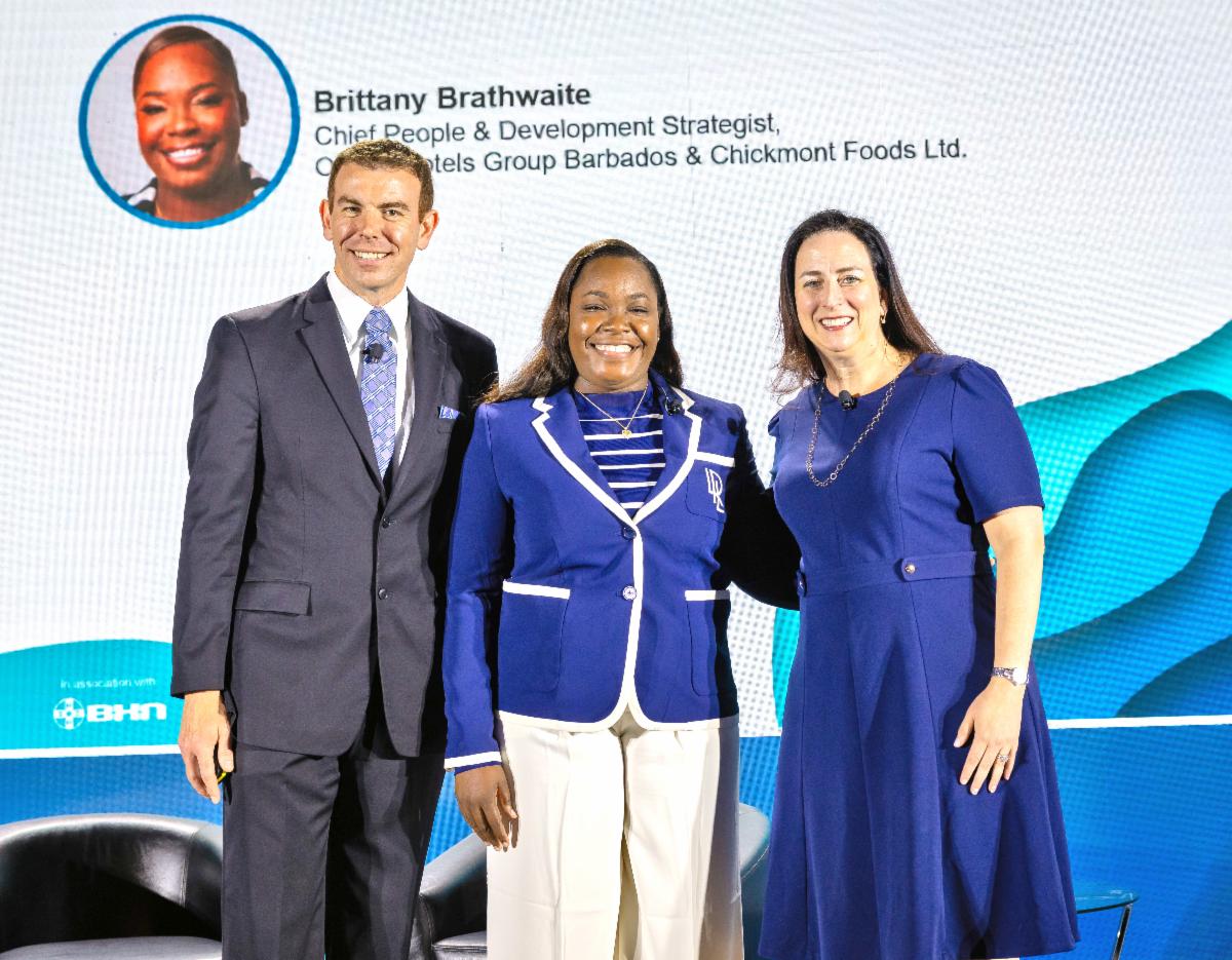 Brittany Brathwaite (center) is congratulated by Jonathon S. Zink, COO of The BHN Group, and Andrea Belfanti, CEO of the International Society of Hospitality Consultants.