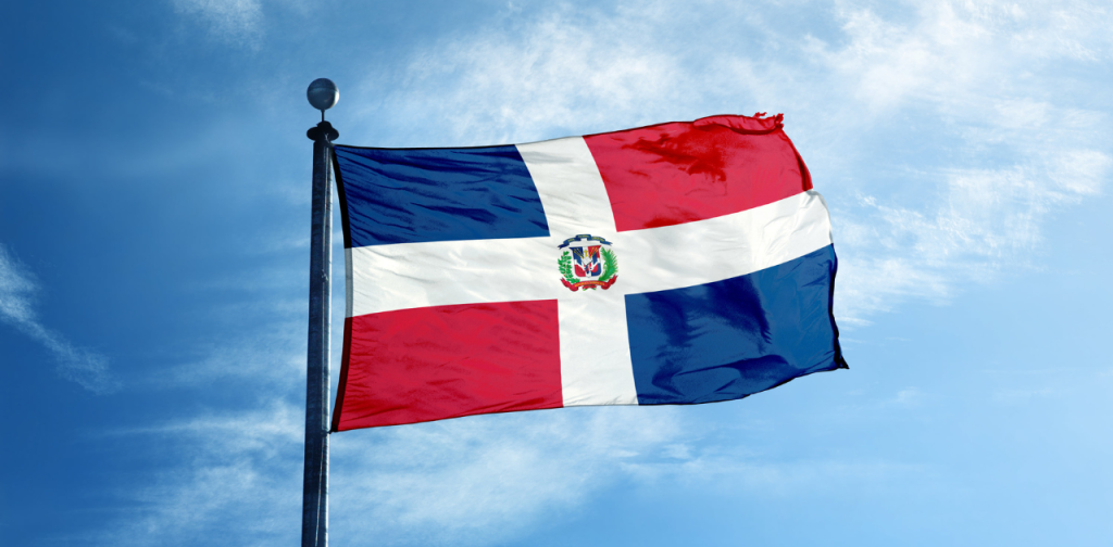 Flag of the Dominican Republic with a blue sky background